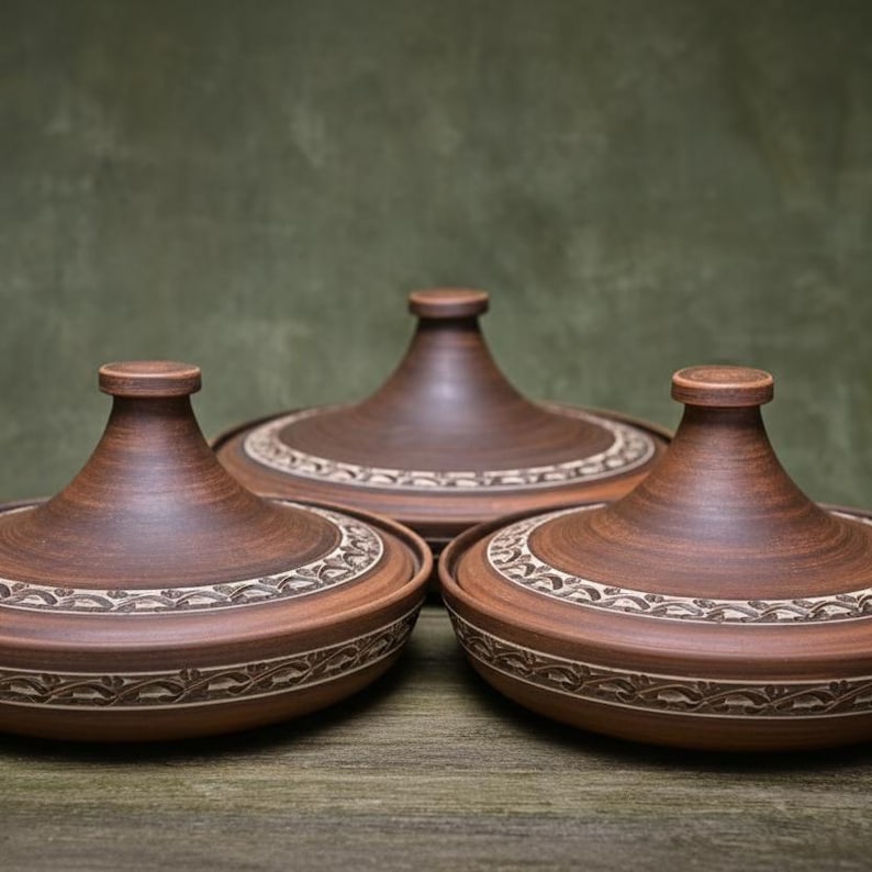 May include: Three brown ceramic tagine pots with conical lids and decorative rims. The tagines are arranged in a row, showcasing their traditional design. The pots are made of earthenware and are suitable for cooking and serving Moroccan dishes.