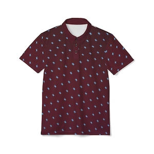 May include: A maroon polo shirt with a white collar and a three-button placket. The shirt has a repeating pattern of small, light blue diamond shapes. The short-sleeved shirt is displayed on a white background.