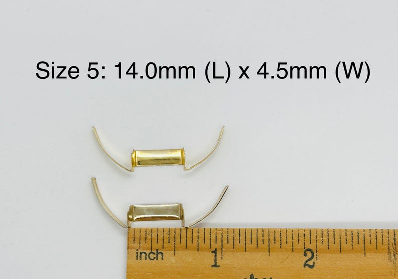 May include: Two gold-toned metal clasps, one on top of the other, are measured with a ruler. The ruler shows the top clasp is 14.0mm long and 4.5mm wide.  Size 5: 14.0mm (L) x 4.5mm (W) is written above the clasps.