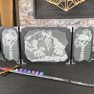 May include: A three-panel tabletop game screen with a black background and a white image of a warrior with a beard. The center panel features the warrior, while the side panels feature a skull and bones design. A sword and dice are in the foreground.