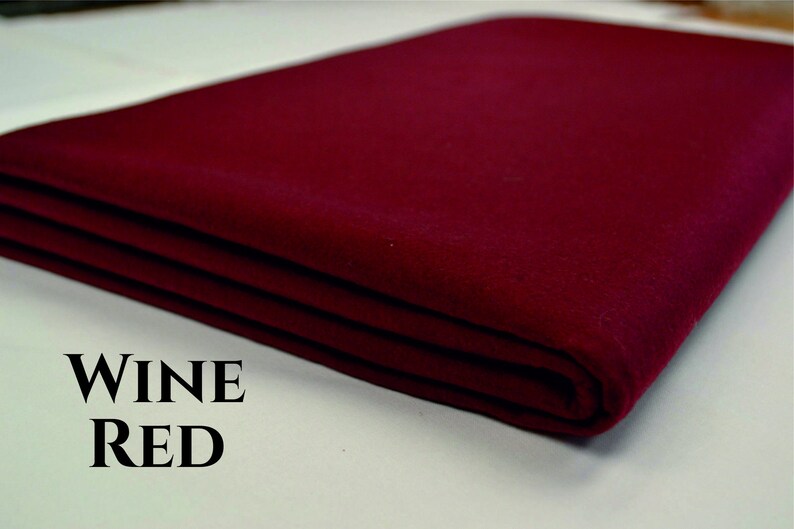 May include: A folded piece of wine red felt fabric. The fabric is smooth and has a slight sheen. The text "WINE RED" is printed below the fabric.