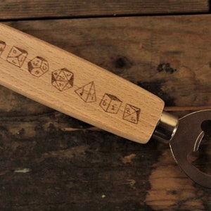 May include: Wooden bottle opener with a metal opener on one end and a handle with engraved dice on the other.