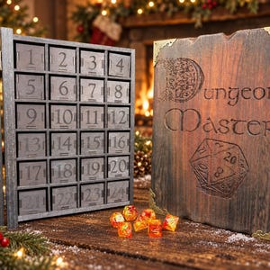 May include: A wooden advent calendar with twenty-four numbered drawers and a matching cover featuring the engraved text Dungeon Master and a twenty-sided die graphic. Several orange and yellow translucent polyhedral dice sit in front.