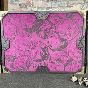 May include: A three-panel folding game screen with a pink velvet background and a pattern of black dice. The screen is made of wood and has a dark brown finish. The screen is closed and is sitting on a black surface.
