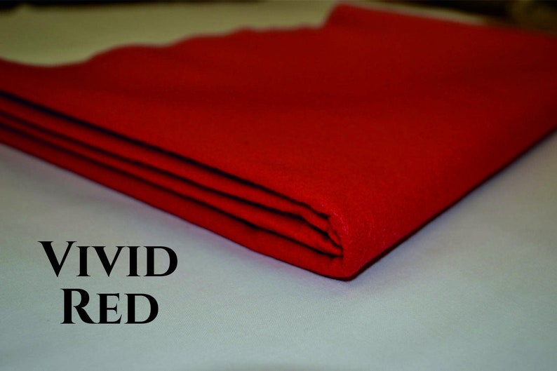 May include: A folded piece of vivid red fabric. The fabric is smooth and has a slight sheen. The text "VIVID RED" is printed below the fabric.