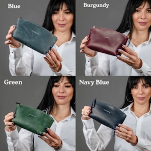 May include: Four different colored leather zippered pouches. The pouches are all the same size and shape. The colors are blue, burgundy, green, and navy blue.