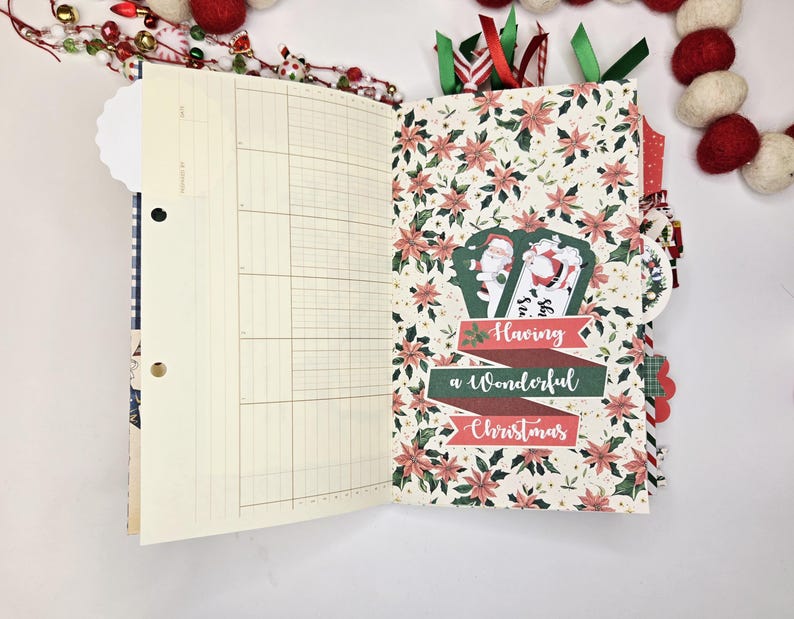 May include: Open journal with lined pages and a Christmas-themed patterned page. The patterned page features red poinsettias and a banner that reads "Having a Wonderful Christmas." Decorative ribbons and embellishments are visible.