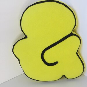 Op de afbeelding: Een gele vilten ampersand met een zwarte omtrek. Het ampersand is een symbool dat staat voor het woord "en".