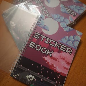 Pixel Art Cityscape Racoon Reusable Sticker Book (50 double sided pages)