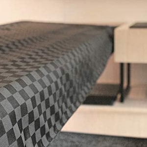 May include: A black and white checkered tablecloth with a smooth, woven texture.