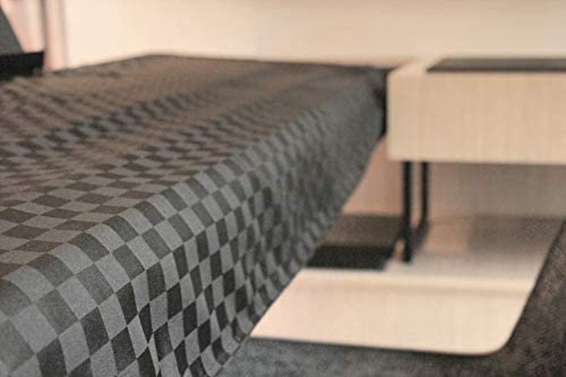 May include: A black and white checkered tablecloth with a smooth, woven texture.