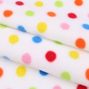May include: White fabric with a colourful polka dot pattern. The dots are in various colours, including red, yellow, blue, green, and pink.