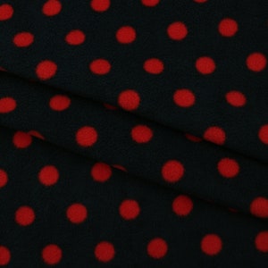 May include: Black fabric with a red polka dot pattern. The fabric is soft and fuzzy, and the dots are evenly spaced.