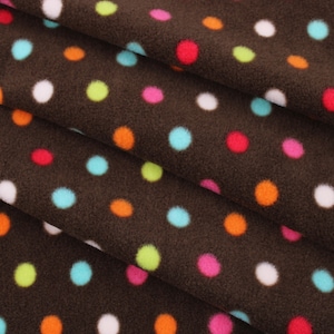 May include: Brown fabric with a polka dot pattern. The dots are in various colours, including red, orange, yellow, green, blue, and white.