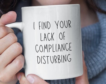 May include: White ceramic mug with black text that reads "I find your lack of compliance disturbing".