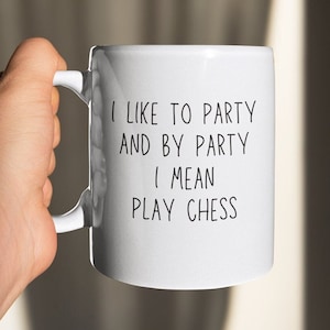 May include: White ceramic mug with black text that reads "I like to party and by party I mean play chess".