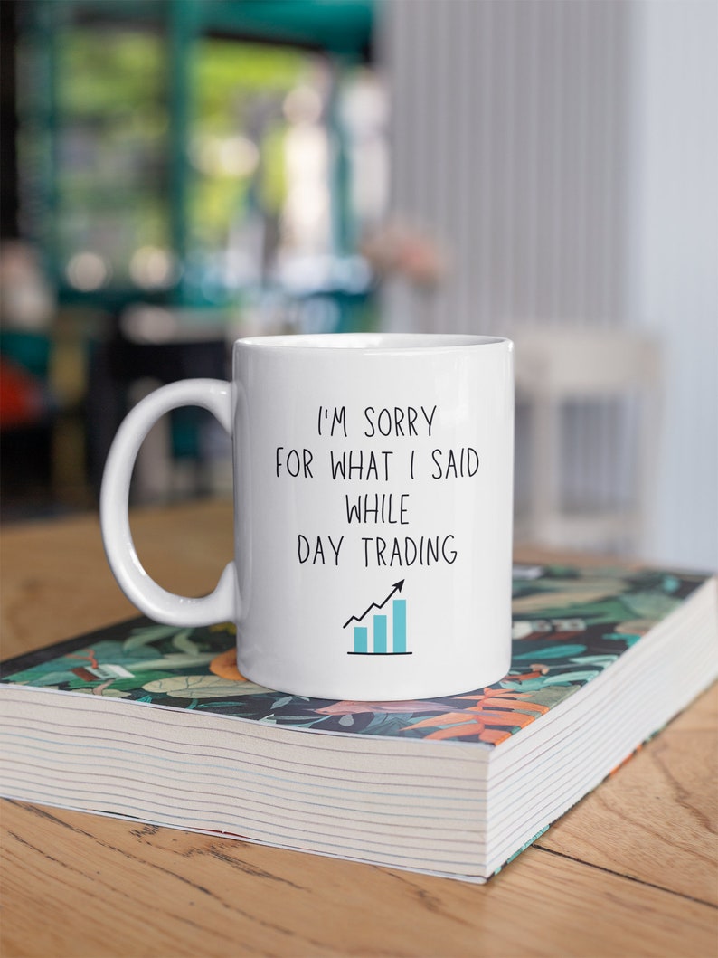 May include: White ceramic mug with a black and blue graphic that says "I'm sorry for what I said while day trading" with a blue line graph.