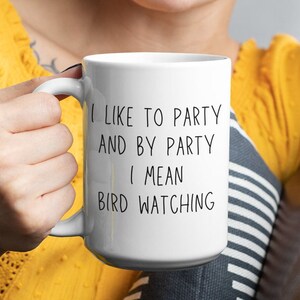 May include: White ceramic coffee mug with black text that reads "I like to party and by party I mean bird watching".