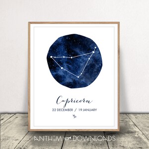 May include: A framed print displaying the Capricorn constellation, depicted with white lines on a dark blue, starry backdrop. The word "Capricorn" is written in cursive below, with the dates 22 December / 19 January.