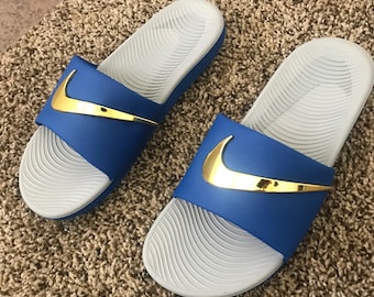 blue and gold nike slides