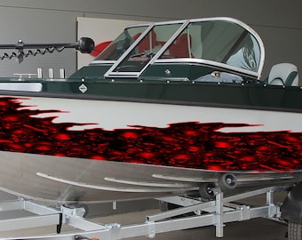 May include: A green and white aluminium boat with a red and black skull graphic on the side. The boat is on a trailer with a black tyre.