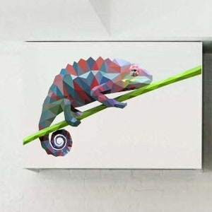 May include: A colorful geometric chameleon decal on a white cabinet door. The chameleon is perched on a green branch and has a blue, pink, and red color scheme.