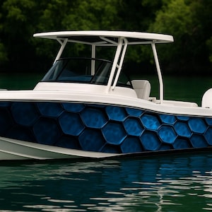 May include: A white and blue motorboat with a distinctive blue honeycomb pattern on the hull. The boat has a white roof and is on the water. The background shows green trees and water.