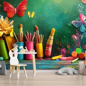 May include: A colorful children's room with a green wall mural featuring butterflies, flowers, and paint splatters. There are paintbrushes, pencils, and crayons in colorful containers on a wooden table. A small white chair and a stuffed animal are in the room.