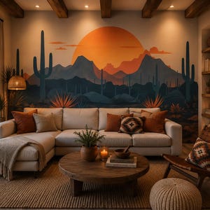 May include: A living room featuring a large sectional sofa with orange and patterned pillows, a round wooden coffee table, and a wall mural depicting a desert landscape with mountains, cacti, and a large orange sun. A fireplace is visible on the right.