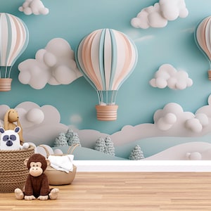 May include: A blue and white nursery wall mural with a paper craft theme. The mural features clouds, trees, and hot air balloons. A wicker basket with stuffed animals sits in the foreground.