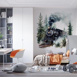May include: A black and gray toy train engine with smoke coming out of the chimney, surrounded by green trees and a watercolor background. The train is on a bed with a gray headboard and orange bedding.