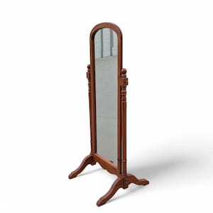 May include: A full-length, wooden, arched-top mirror. The mirror is framed in a rich, dark brown wood and stands on a decorative base. The mirror's frame features ornate details and a classic design, suitable for a bedroom or dressing area.