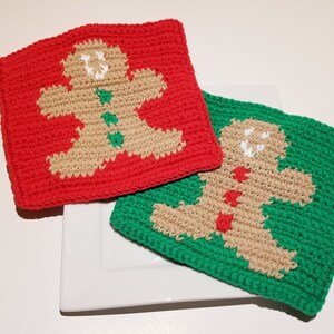 May include: Two crocheted gingerbread man pot holders, one red and one green, with white icing details.