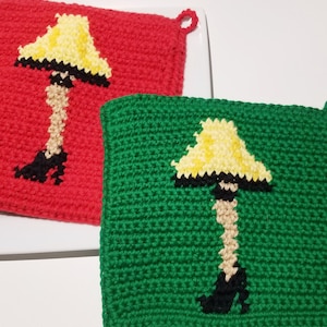 May include: Two crocheted pot holders with a leg lamp design. One is red and the other is green.