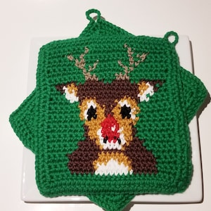 May include: Green crocheted pot holder with a reindeer design. The reindeer has brown antlers, a brown nose, and a red nose.