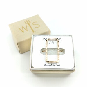 May include: Gold rectangle ring in a white box with the words "White Sand Jewellery" and "Handmade in Hawaii".