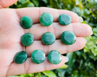 May include: Eight round, green gemstone cabochons. The cabochons are smooth and polished, with a slightly irregular shape.