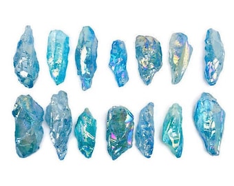 May include: A collection of 14 iridescent blue crystal points. The crystals are all different sizes and shapes, but they all have a similar blue color with a rainbow sheen.