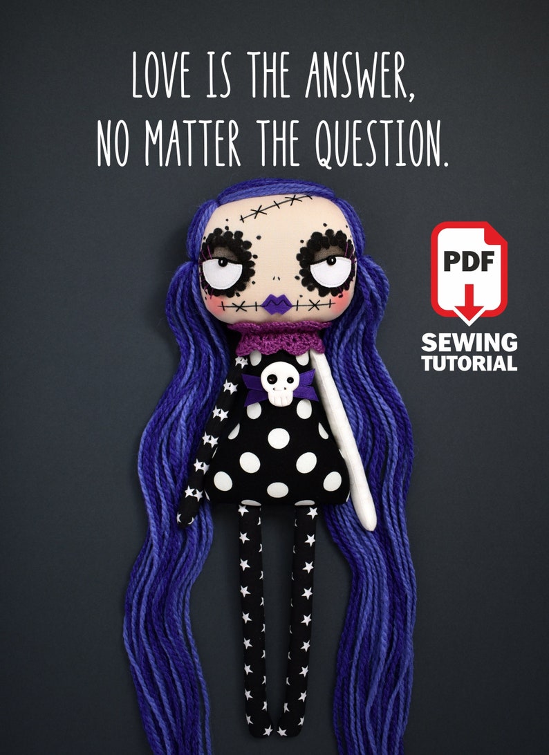 full body view of dark cute gothic fabric doll with large round eyes, black dress decorated with white stars and polka dots, multi-toned purple hair, standing pose, shown in sewing tutorial with PDF pattern, holding quote “Love is the answer no matter the question”