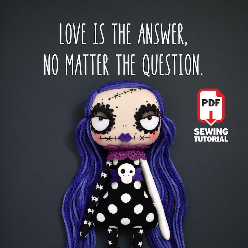 dark cute gothic fabric doll with large round eyes, black dress with white polka dots and stars, purple gradient hair, shown in sewing tutorial with printable PDF pattern, holding quote “Love is the answer no matter the question”