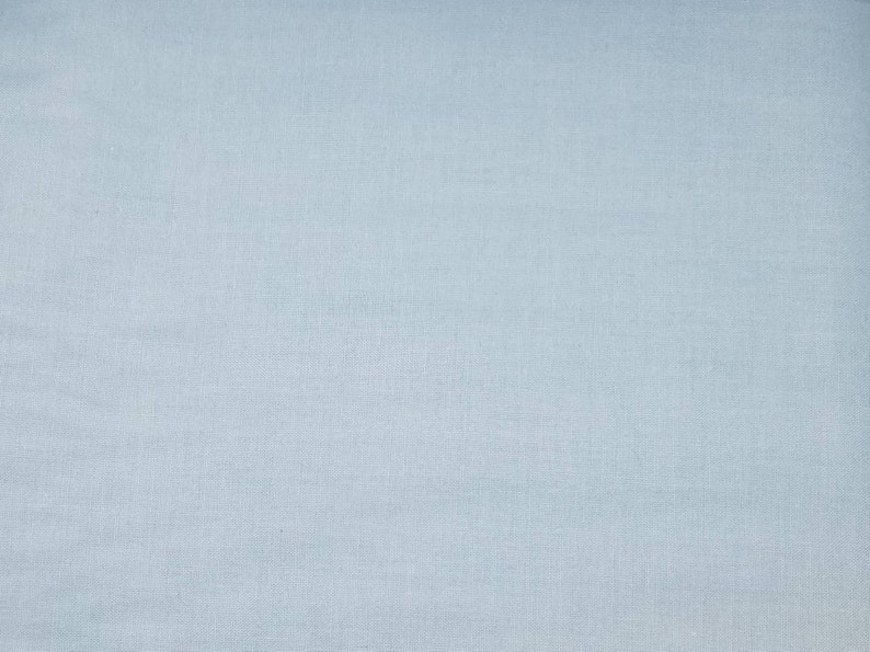 May include: A plain light blue fabric with a subtle woven texture.