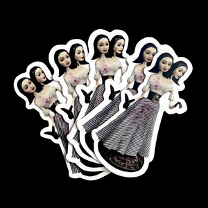 May include: Set of six white stickers featuring a black and white illustration of a woman in a striped dress. The woman has black hair and a pale complexion. The stickers are arranged in a circle.
