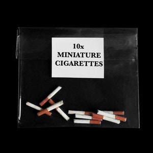May include: A clear plastic bag containing 10 miniature white and orange cigarettes. The bag has a label that reads "10x Miniature Cigarettes".