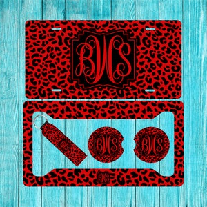 May include: A red and black leopard print car license plate frame set with matching coasters and a keychain. The set features a monogrammed initial "BJS" in a black and white font.