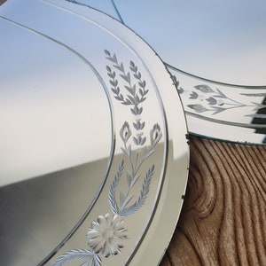 Puede incluir: Dos espejos ovalados con dise&ntilde;os florales grabados. Los espejos son plateados y tienen un borde biselado.