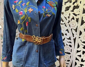 vintage 1970’s embroidered denim chore jacket with pockets. Best fits S to M. Embroidery at chest and cuffs.