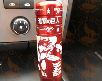 May include: Red gear shift knob with a white graphic of a character from the anime "Attack on Titan" and the Japanese text "Shingeki no Kyojin".