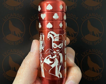 May include: Red metal container with a Harley Quinn graphic and playing card symbols. The container is about 6 inches tall and has a screw-on lid.