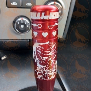May include: Red metal gear shift knob with a white graphic of an anime character and the text "Kill la Kill".