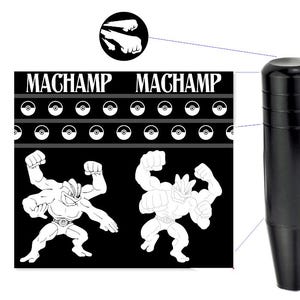 May include: Black shift knob with a cylindrical design. The image also features a black and white graphic with the word "MACHAMP" and illustrations of the Machamp character from the Pokémon franchise.